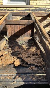 Roof replacement in progress on a real estate investment property managed by a project team.