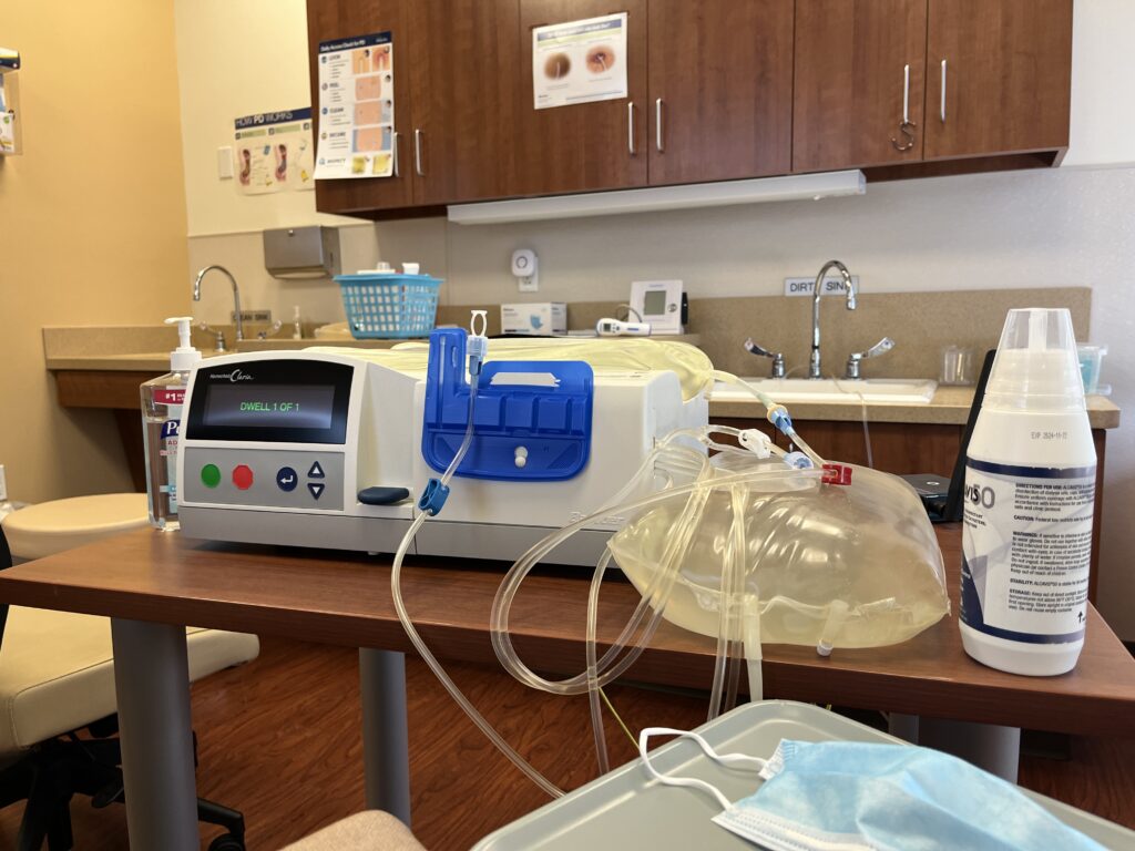 A home peritoneal dialysis setup with medical equipment neatly arranged in a quiet bedroom, symbolizing resilience and daily routines of kidney care.