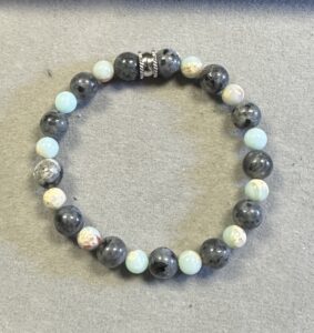 Handmade black lava and royal blue sea sediment jasper bracelet featuring matte volcanic and polished gemstone beads