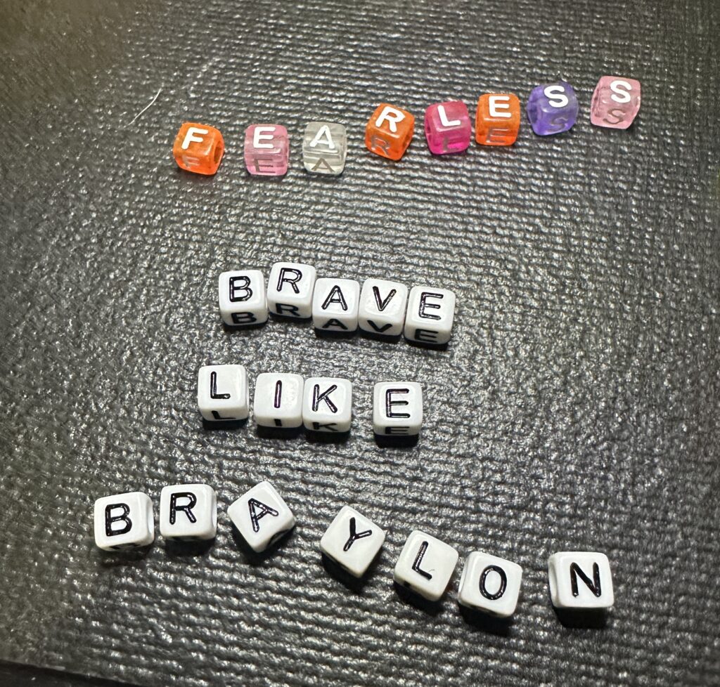 Simple white letter beads spelling Braylon Strong on handmade bracelet design