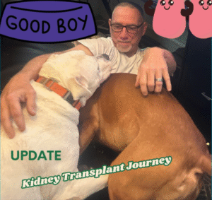 Man sitting with two loyal dogs during a quiet moment at home, symbolizing comfort and support during a kidney transplant journey update.